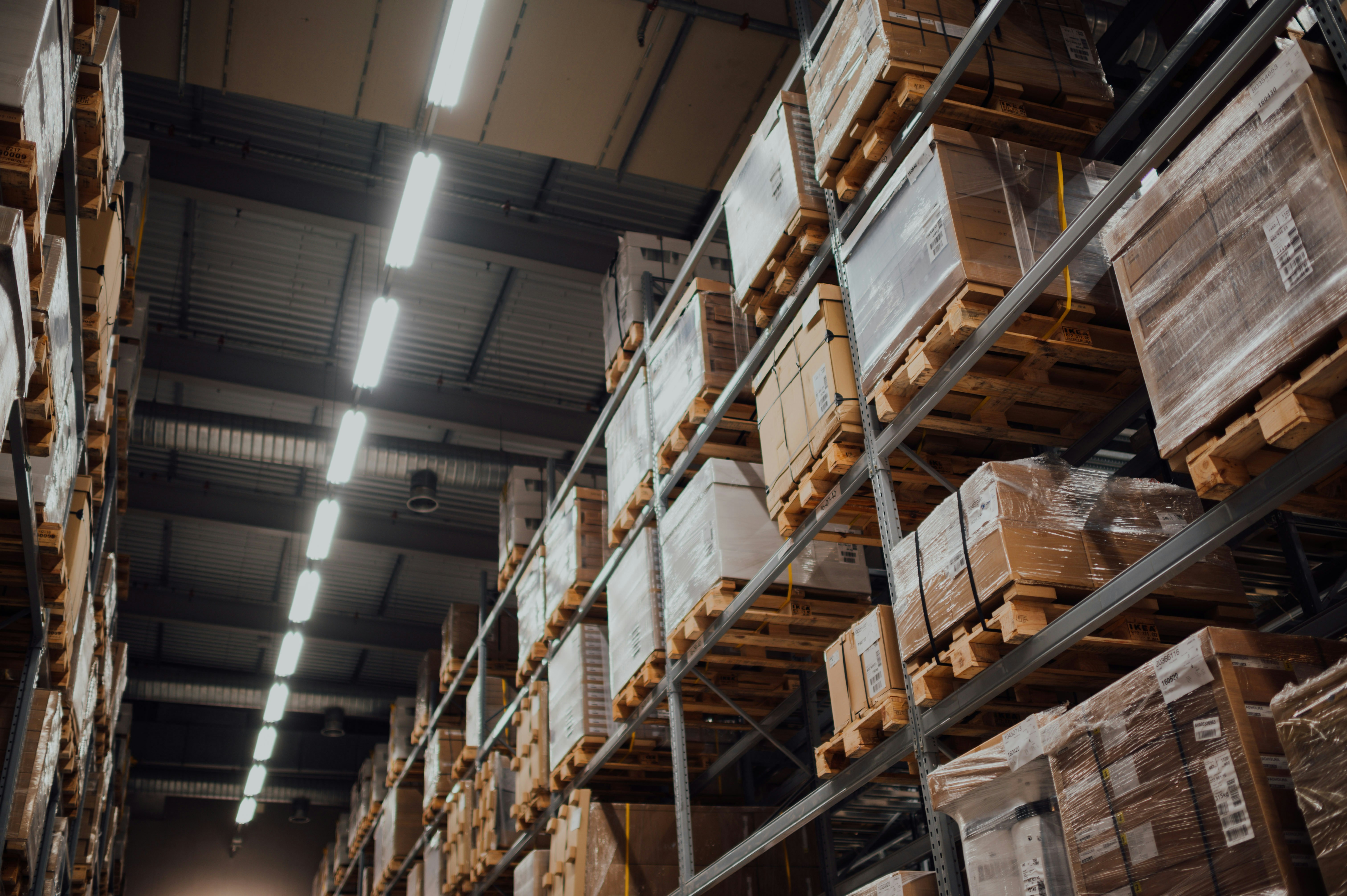 Warehouse aisles with pallets and forklift